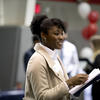 African American woman holding resumes at a job fair