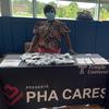 PHA CARES Community Health Worker sharing information at a resource fair